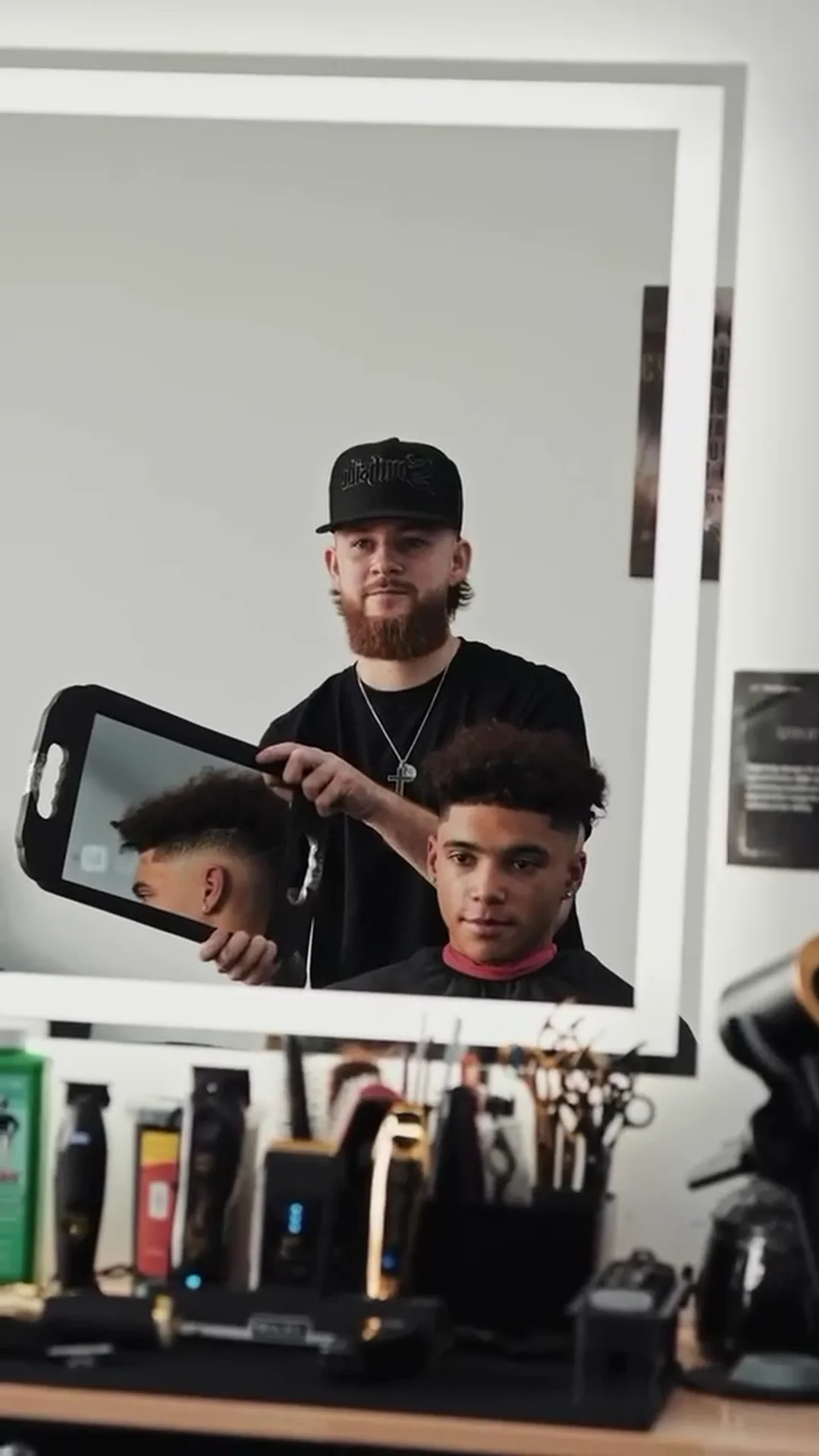 A barber showing a client the finished cut
